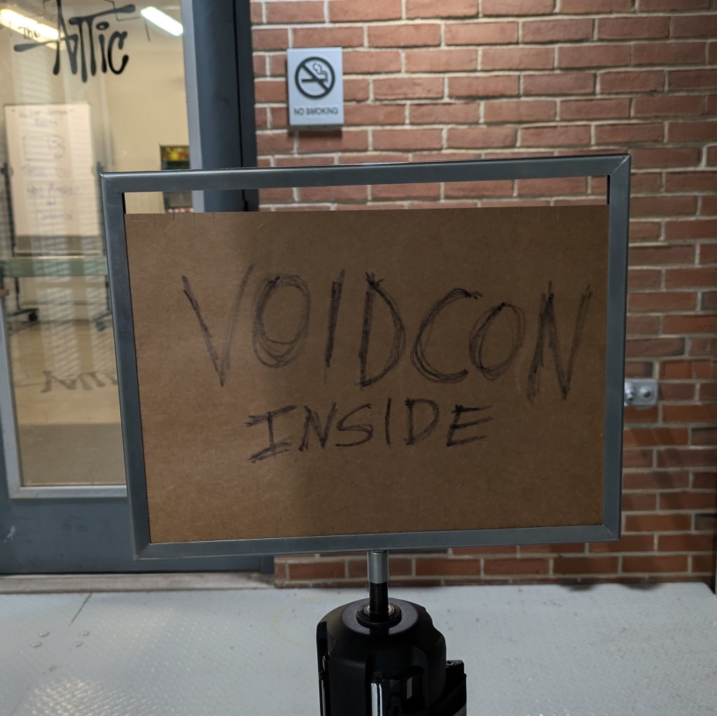 Sign reading "VOIDCON Inside"