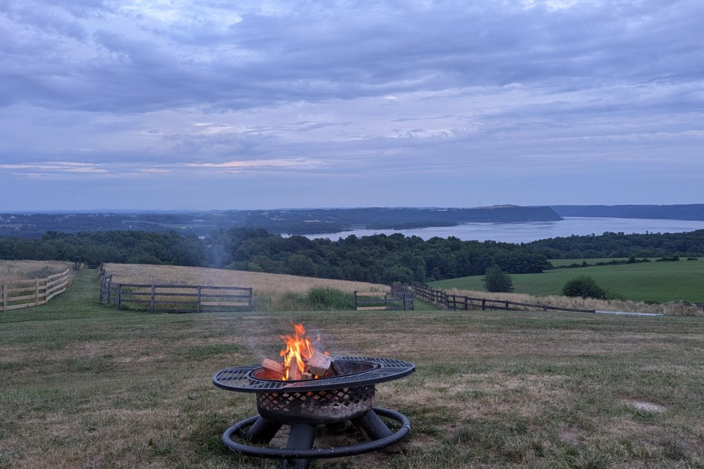 A fire burning with a river behind it.